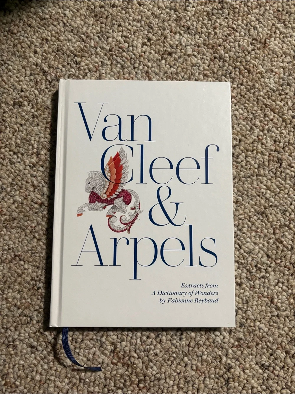 Van Cleef & Arpels White Cover Book with Blue Lettering and Red Accent